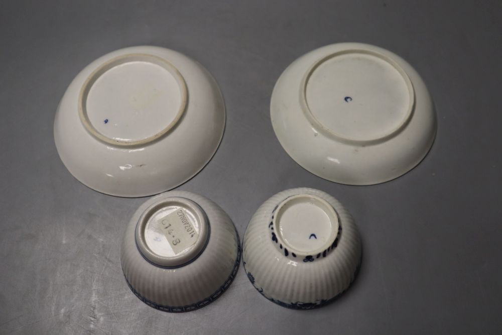 Two Worcester reeded teabowls and saucers, one with Dark Sprig Centre and the other with a border pattern, 12cm